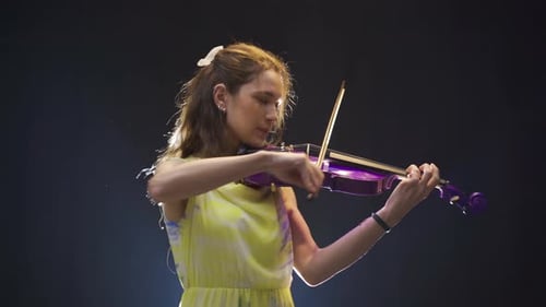 Woman Plays Purple Violin on Stage