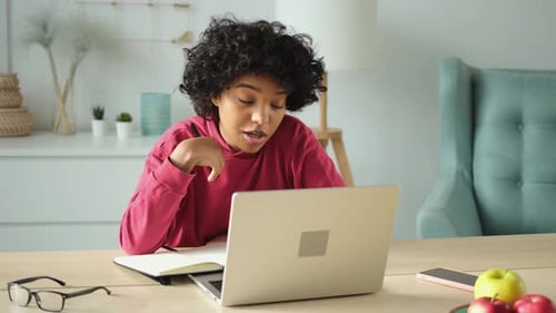 Young Adult Working on Laptop at Home