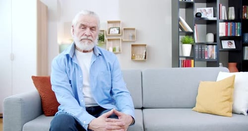 Senior Man Sitting on Couch in Living Room