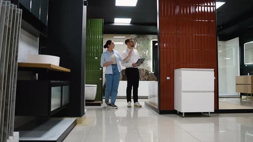 Couple Choosing Bathroom Fixtures with Consultant in Showroom