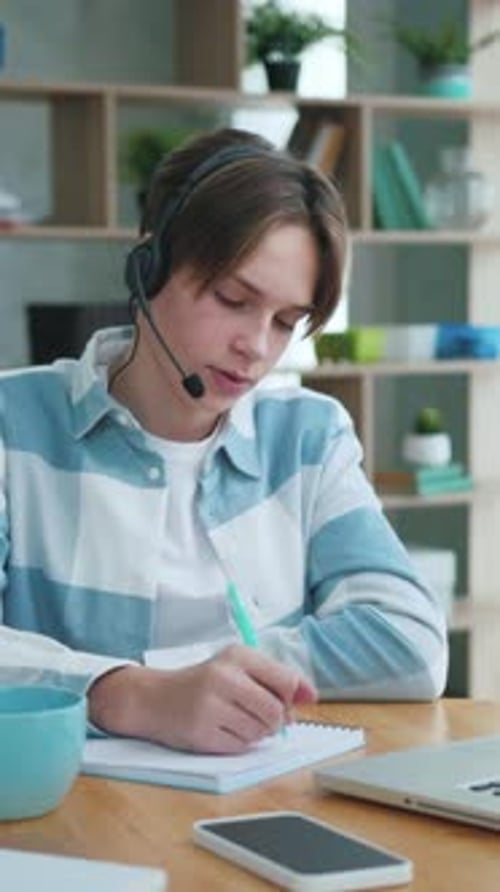 Young Adult Learning Online at Desk