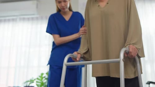 Close up of senior woman patient doing physical therapy with caregiver.