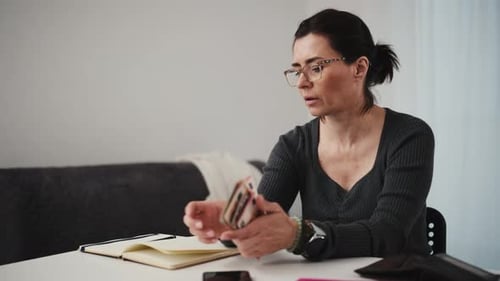 Woman Planning Expenses And Counting Money