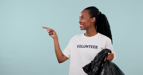 Plastic bag, black woman point or volunteer okay wink for trash cleaning news