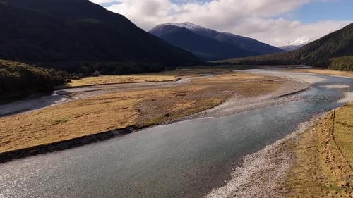 Stunning New Zealand Valley Winding River Flows Through Golden Grasslands
