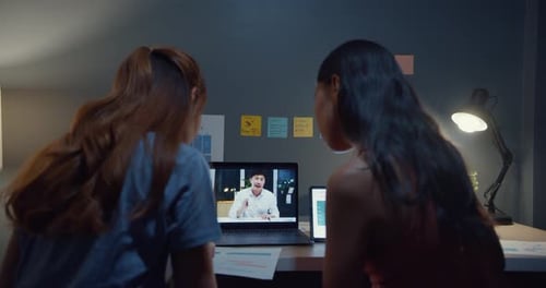 Colleagues Conferencing Online With Coworker at Home