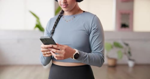 Phone, typing and hands of woman for yoga in studio for wellness, health tips