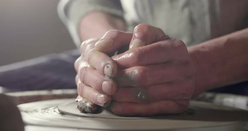 Hands Shaping Clay on Pottery Wheel Close Up