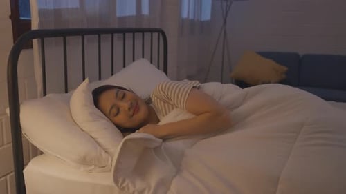 Asian beautiful woman lying down on bed in bedroom, dreaming at night.