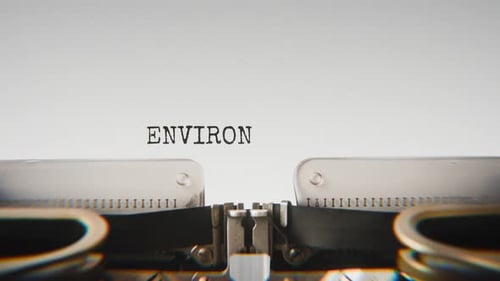 Old mechanical typewriter typing Environmental Impact in a close-up view.