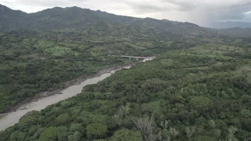 Bridge On Lush River Landscape and Mountain Range