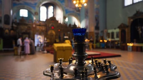 A Closeup of a Candle Holder in a Church with a Beautifully Defocused Interior Background