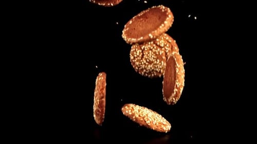 Super Slow Motion Fresh Oatmeal Cookies with Sesame Seeds Falls on the Table