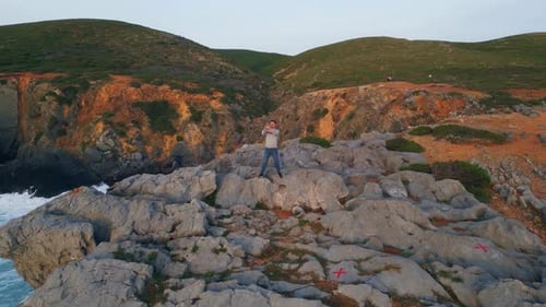 Man Standing Cliff Photographing Seashore Nature Green Hills Marine Environment