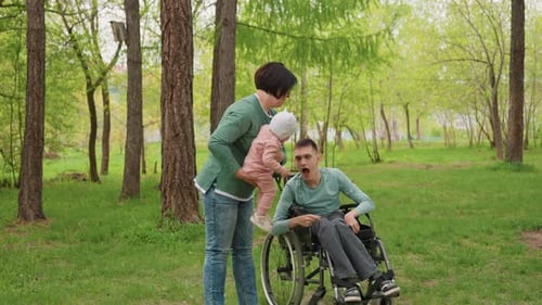 Woman and Baby with Teenage Boy in Wheelchair