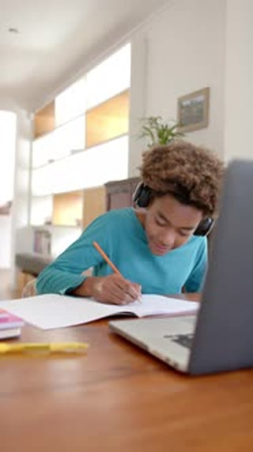 Teen Boy Studying at Home with Laptop