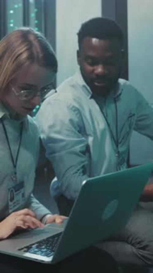 Data Center Team Assesses Server Issues Focused Team Members Analyze and Repair Data Center