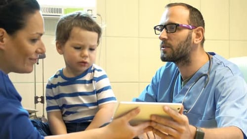 Doctor Explains Something to Child in Hospital Room