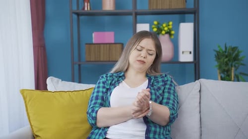 Woman Massaging Wrist Due to Injury or Pain