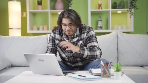Young Adult Video Calling From Home on Laptop