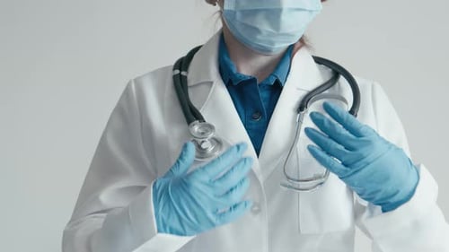 Medical Professional Wearing Mask, Gloves, and Lab Coat