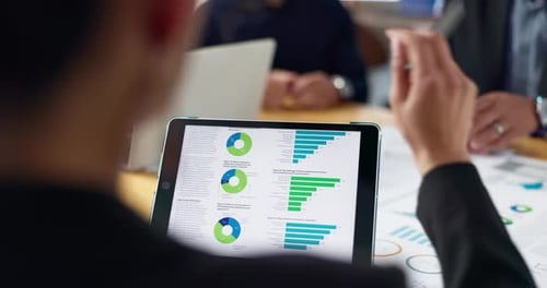 Business Meeting with Charts on Tablet
