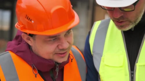 Civil engineer arguing worker man, analyzing construction blueprint online, close up