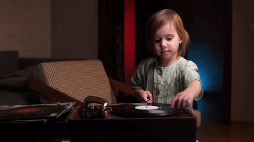 Young Girl Plays Vintage Record Player at Home