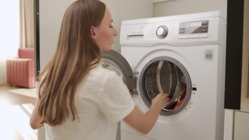 Woman Doing Laundry in Washing Machine