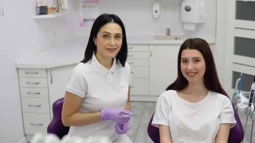 Dentist and Patient Smiling in Medical Office
