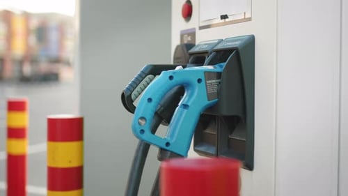 Electric Charging Station with Blue and Black Power Cords Blurred Background of