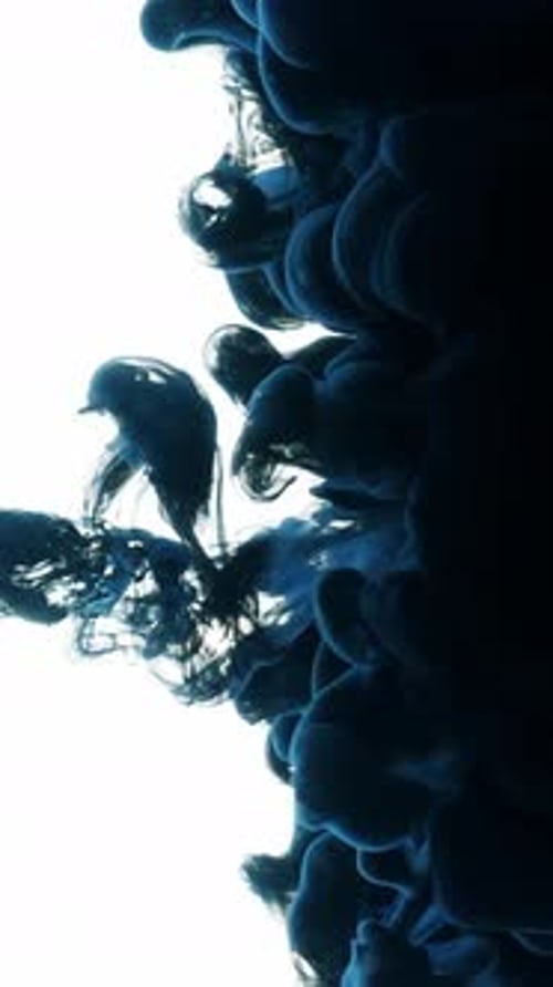 Abstract Blue Ink Cloud Forming on White Background