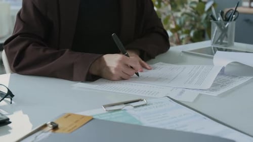 Woman Signs Business Loan Agreement in Office