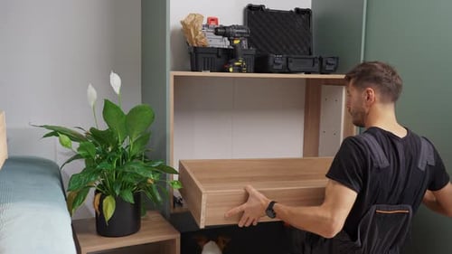 Man installing drawer in home improvement project