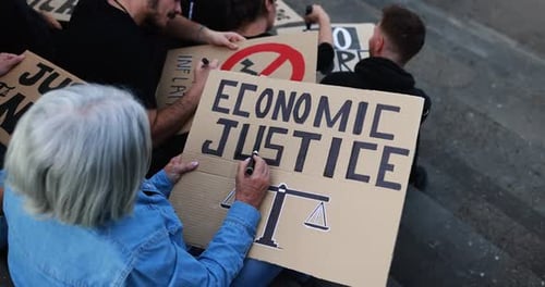 Crowd of multiracial people prepare banners against inflation and financial crisis