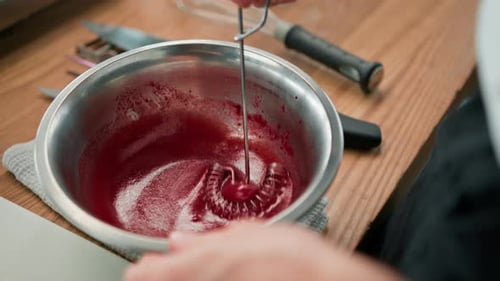 Professional kitchen chef prepares red beetroot sauce for salad mixes ingredients healthy food
