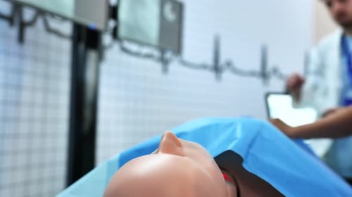 Medical Students Practicing on a Simulator Mannequin in a Modern Training Center