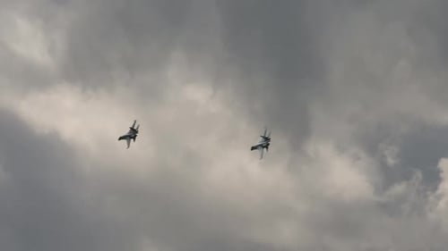 Two Military Jet Planes Flying in Cloudy Sky