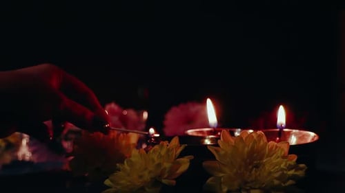 Hand Lights Candles and Flowers for Celebration