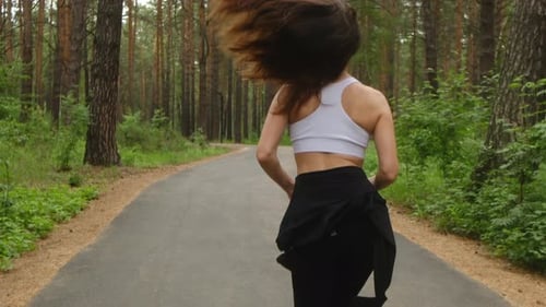 Young Sportswoman Running in the Park