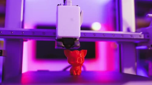 3D Printer Creating Red Cat Figurine