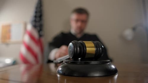 Judge's Gavel on Desk in Courtroom Setting