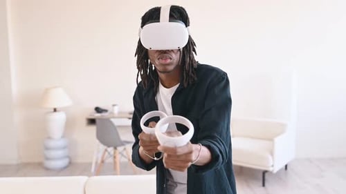 Young Man Uses VR Headset in Modern Apartment