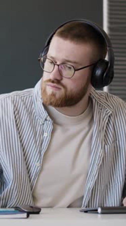 Man Checking Notification On Smartphone At Work