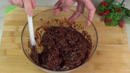 Man Mixing Chocolate in Bowl with Spatula