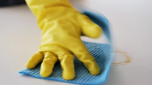 Cleaning White Surface with Cloth and Yellow Glove