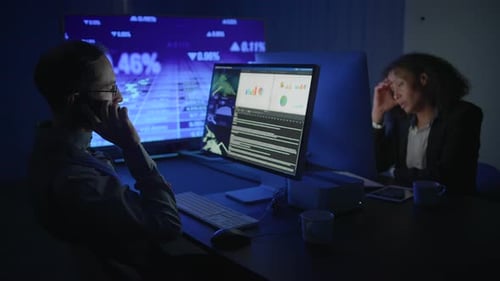 Business Professionals Engaged in Analyzing Data Within a Modern Office Environment