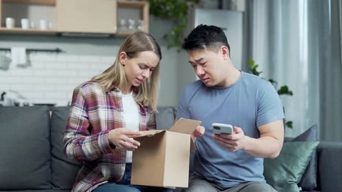 Woman and Man Open Disappointing Package at Home
