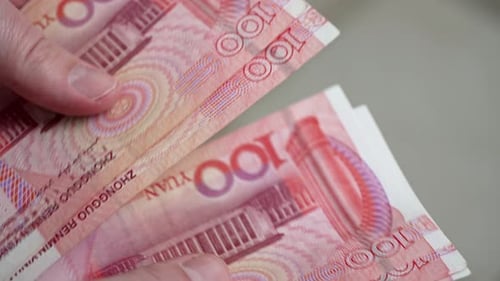 Businessman Counts Chinese Yuan Amid Rising US-China Trade Tariffs