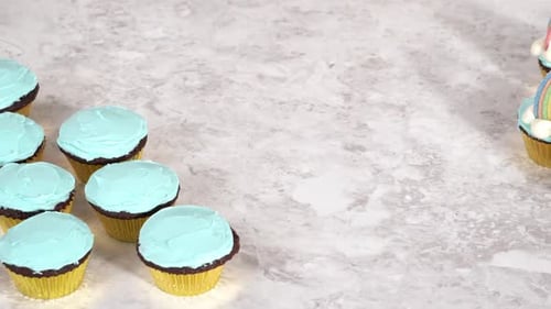 Decorating Chocolate Cupcakes with Buttercream Frosting and Rainbow Candy